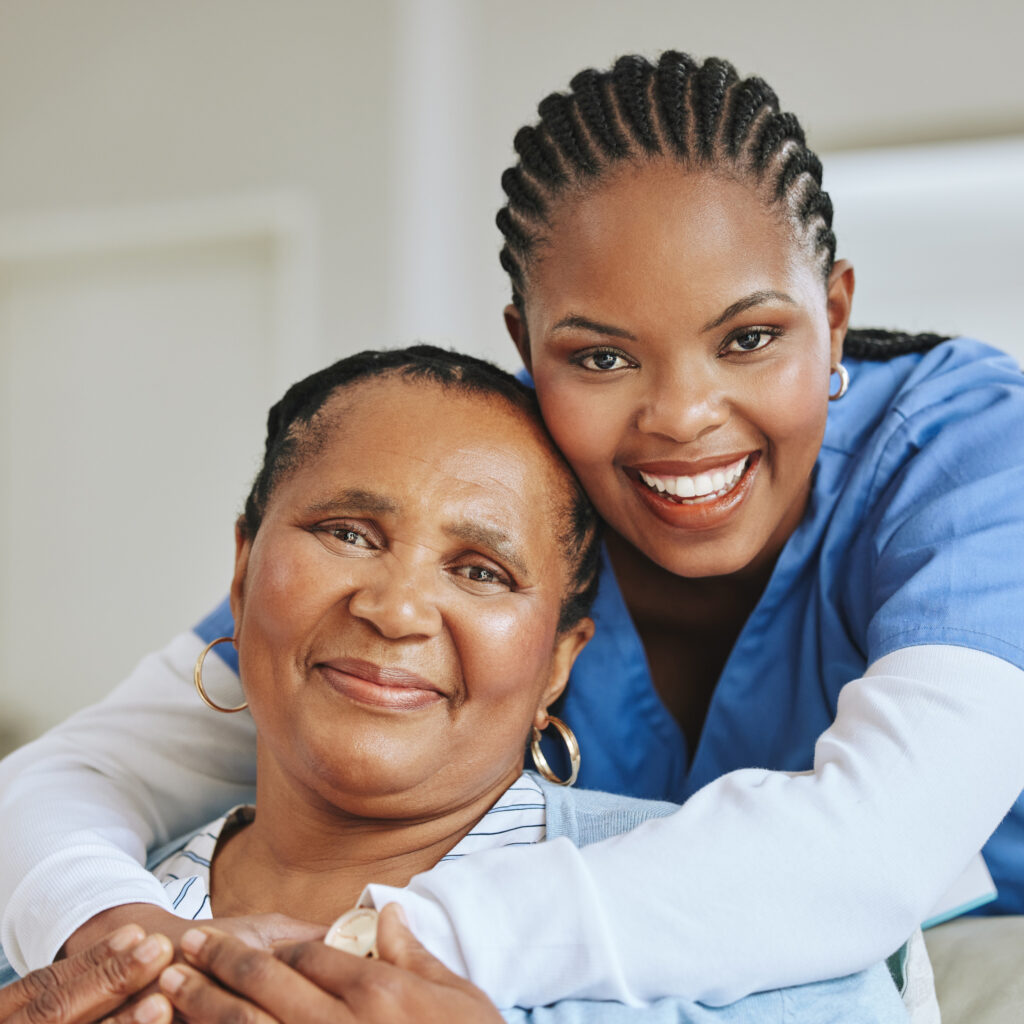 A caregiver standing with older adults in a warm homecare setting